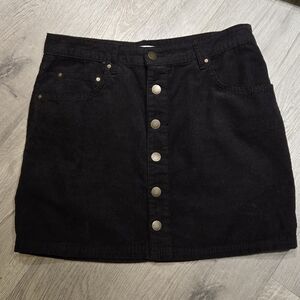 Billabong Corduroy Black Mini Skirt with gold button details.
